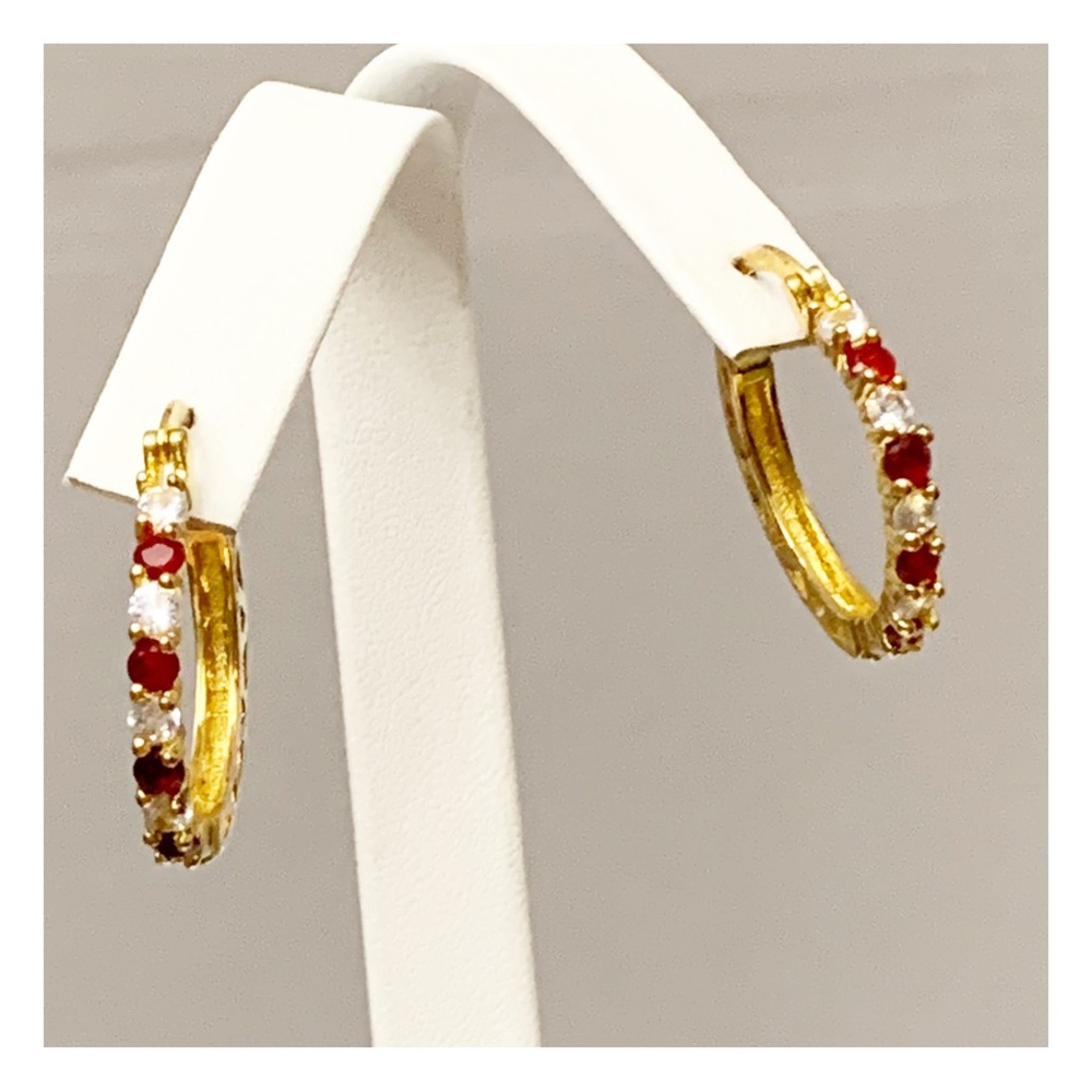 Gold tone hoop earrings with red and clear stones